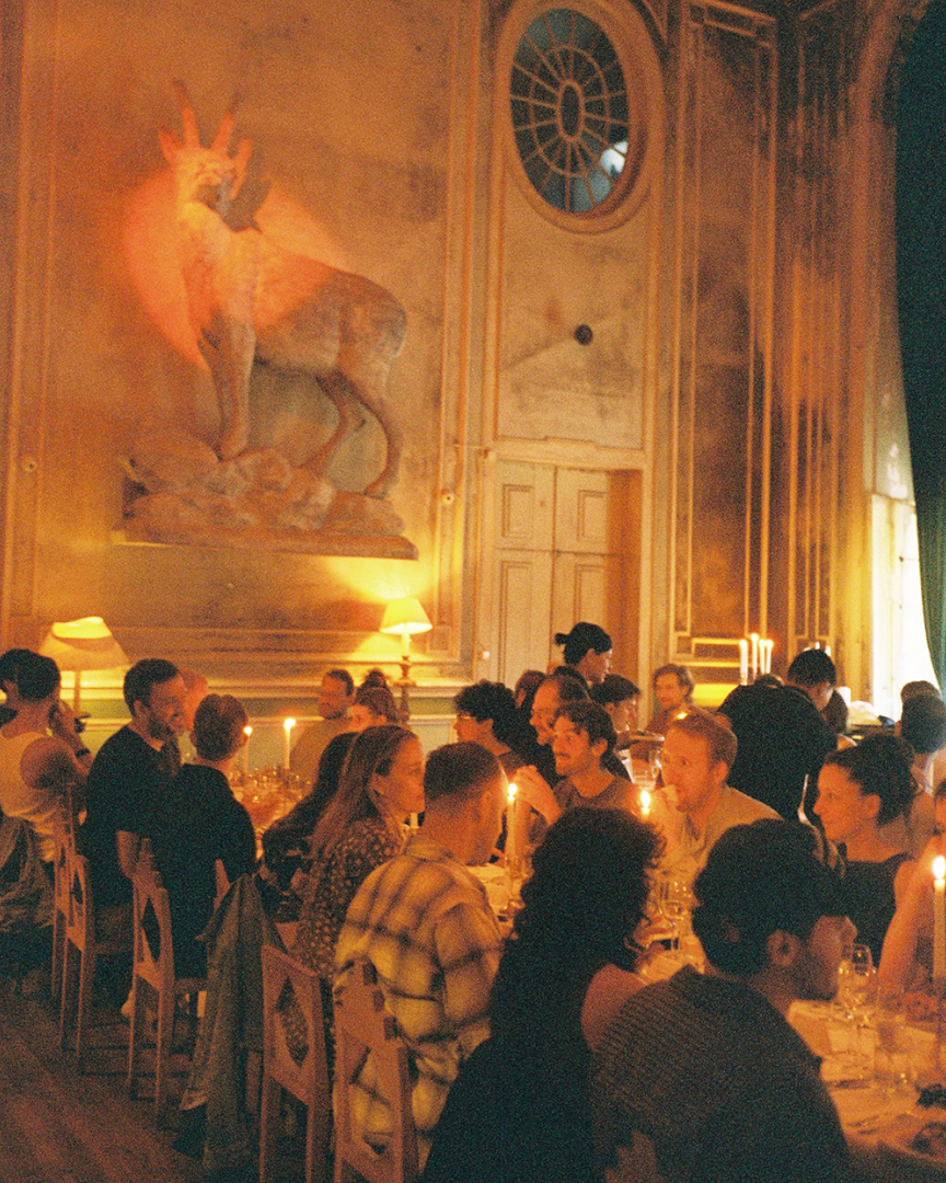 A group dinner in a classic building, warm lighting