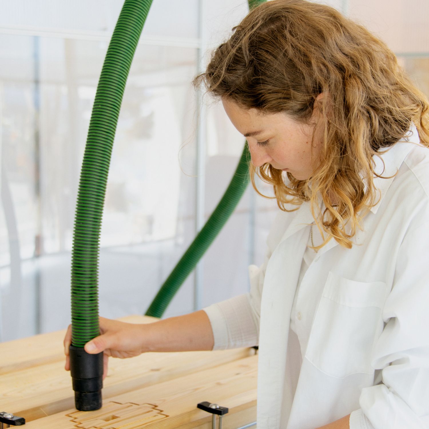 Designer Tanita Klein working on the physical design of the BeeHome, wearing a white shirt.