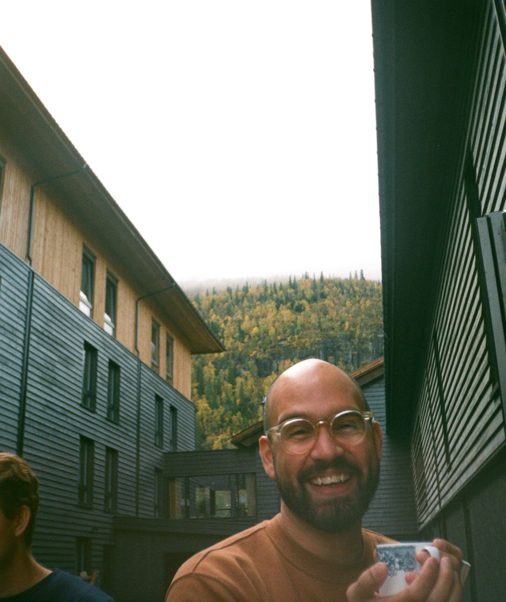 Smiling man holding a cup