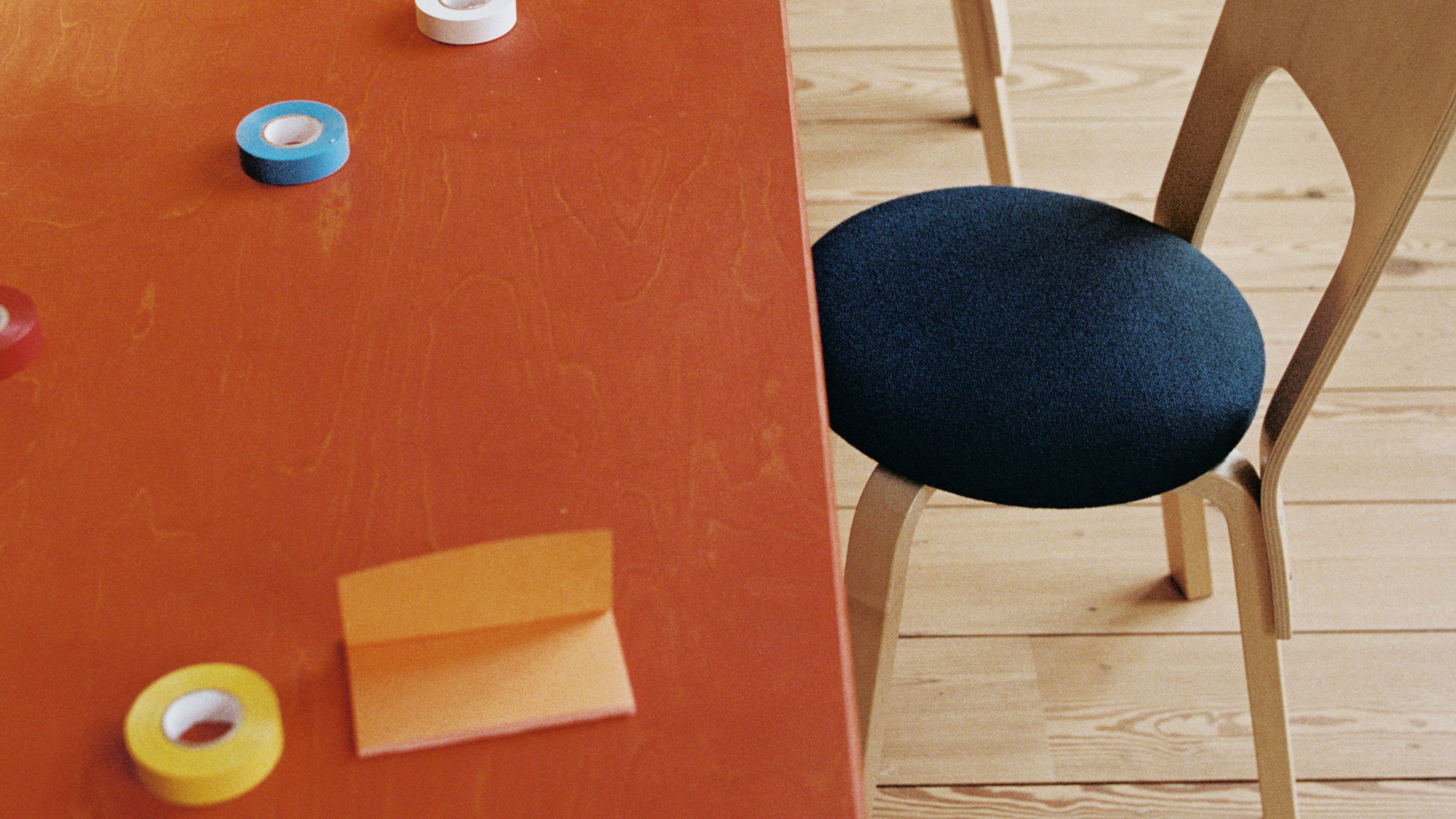 office table with office supplies, a chair shows next to it