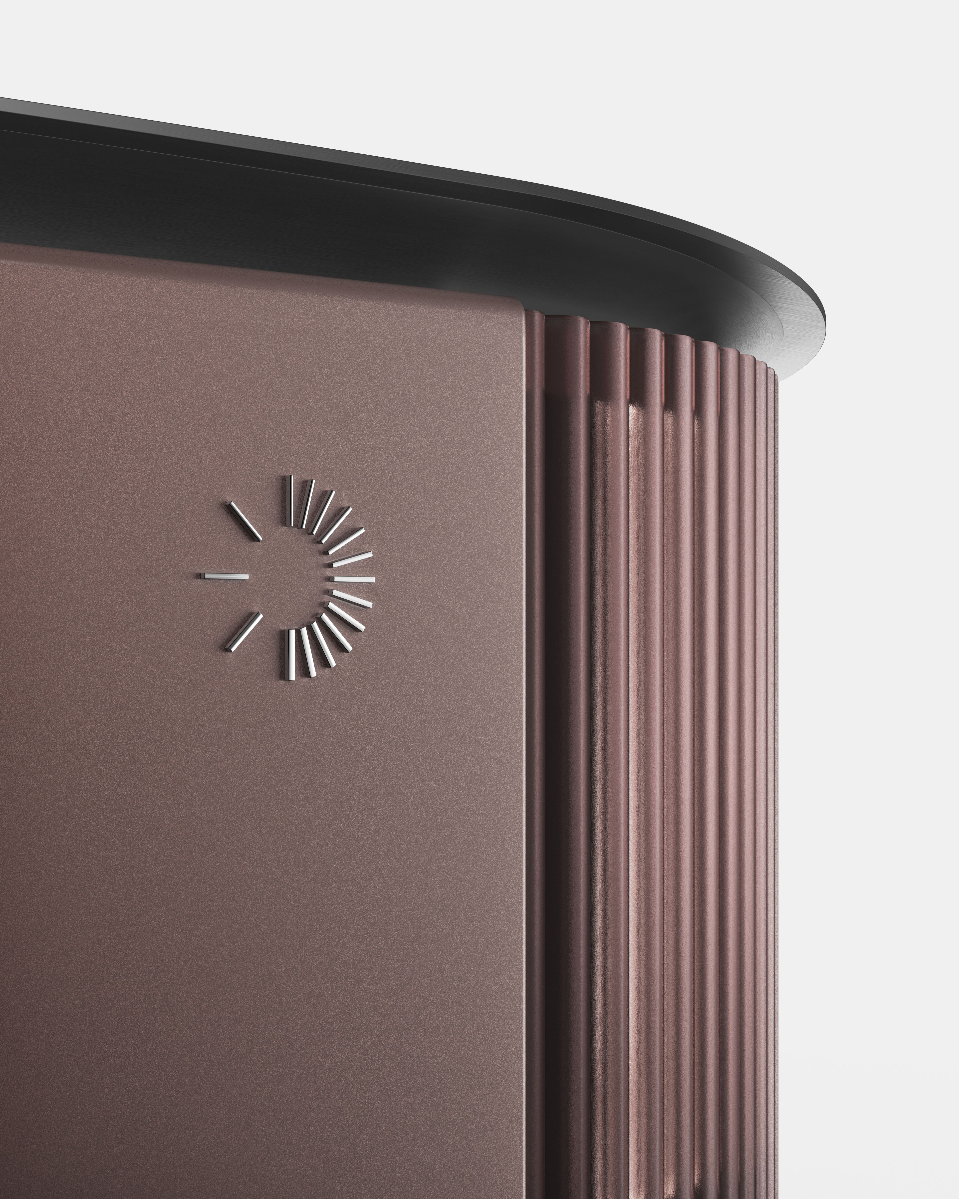 A close-up shot of a modern, sleek appliance with a metallic bronze-red finish. It features a fluted, textured side panel, a smooth front surface with a raised silver semi-circular dash icon, and a dark, rounded top edge.