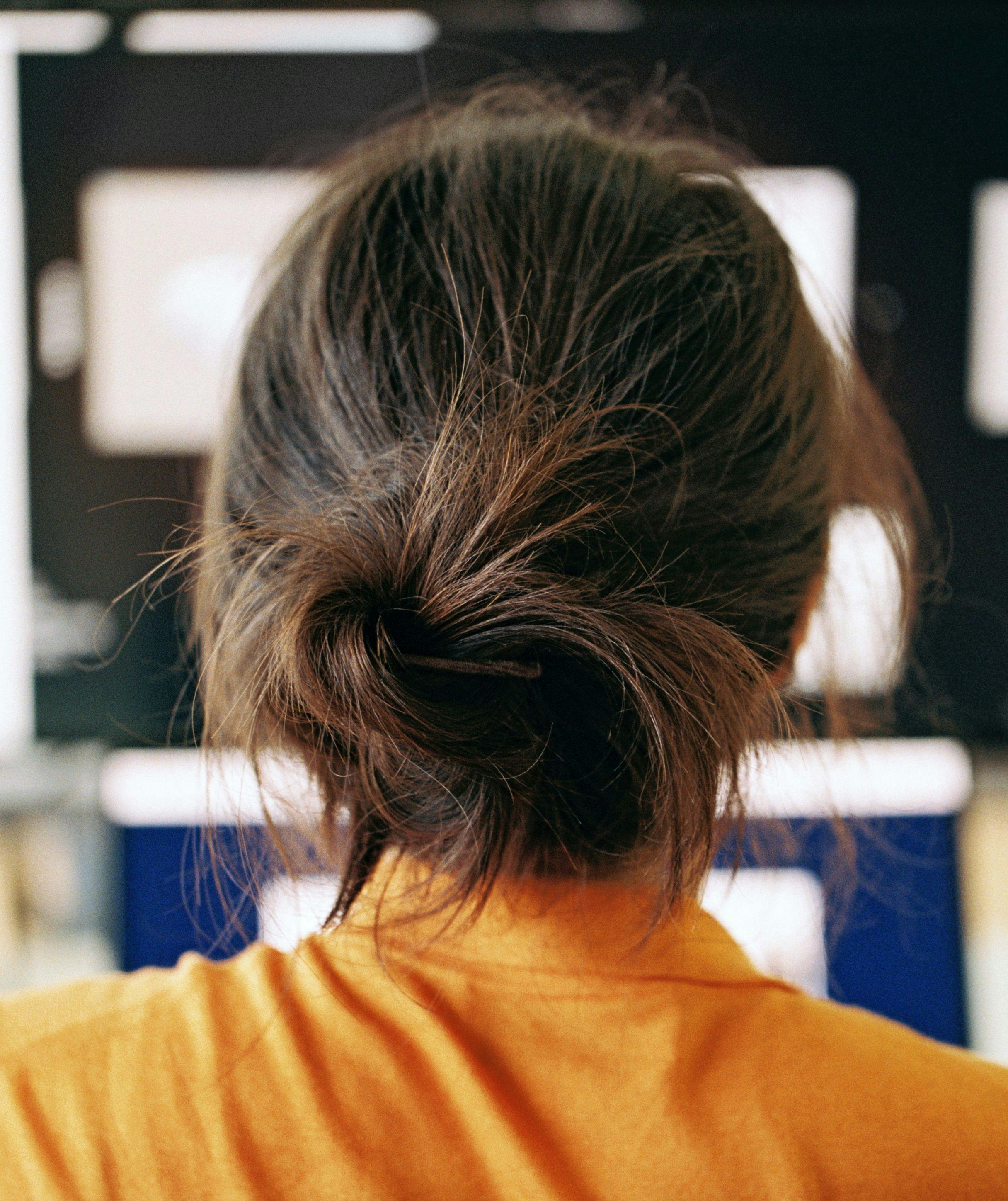 A close-up of a woman's hair seen from behind