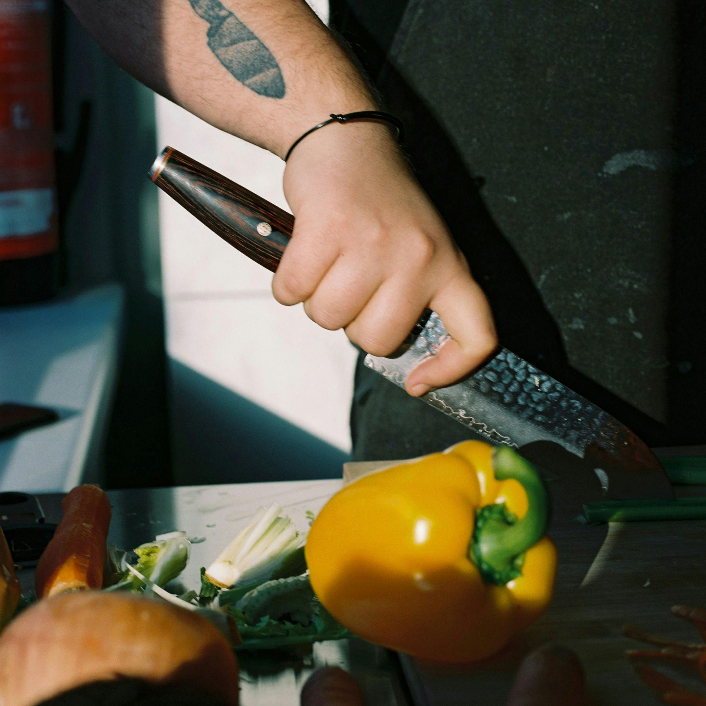A man slicing peppers