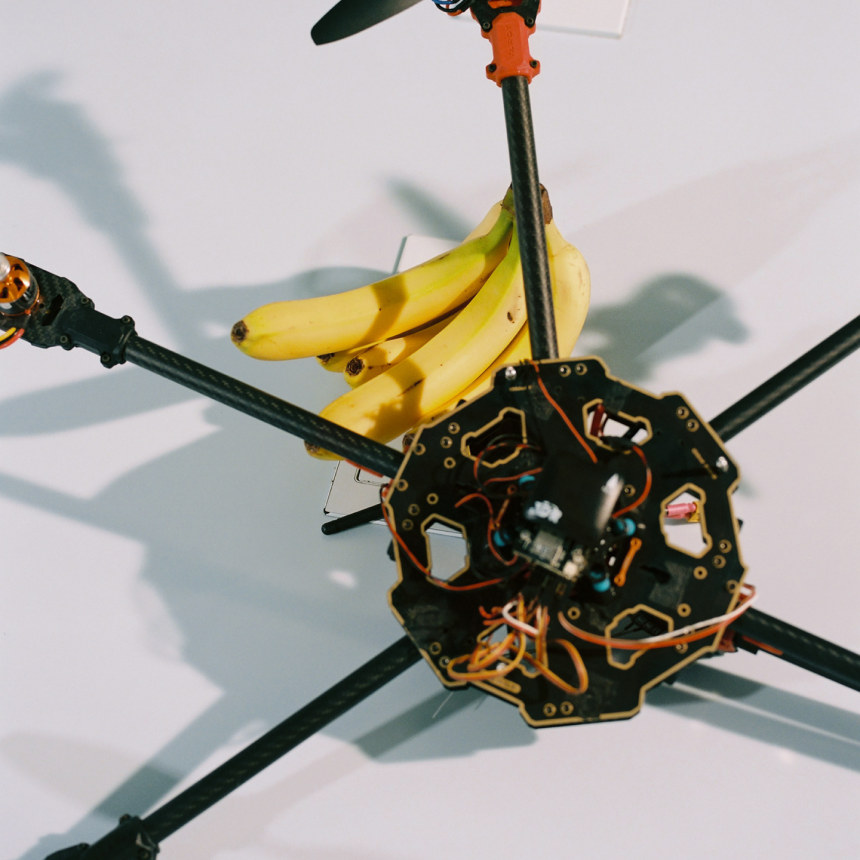 A drone with bananas attached to it sitting on a desk