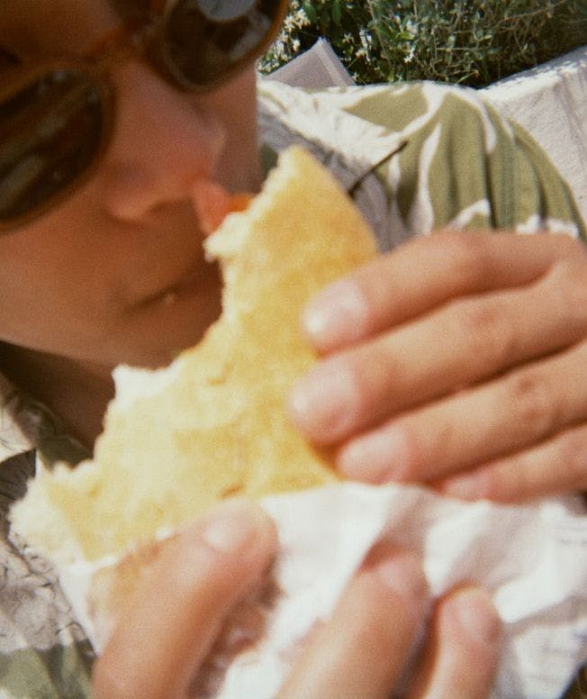 Close-up of a person eating a sandwich