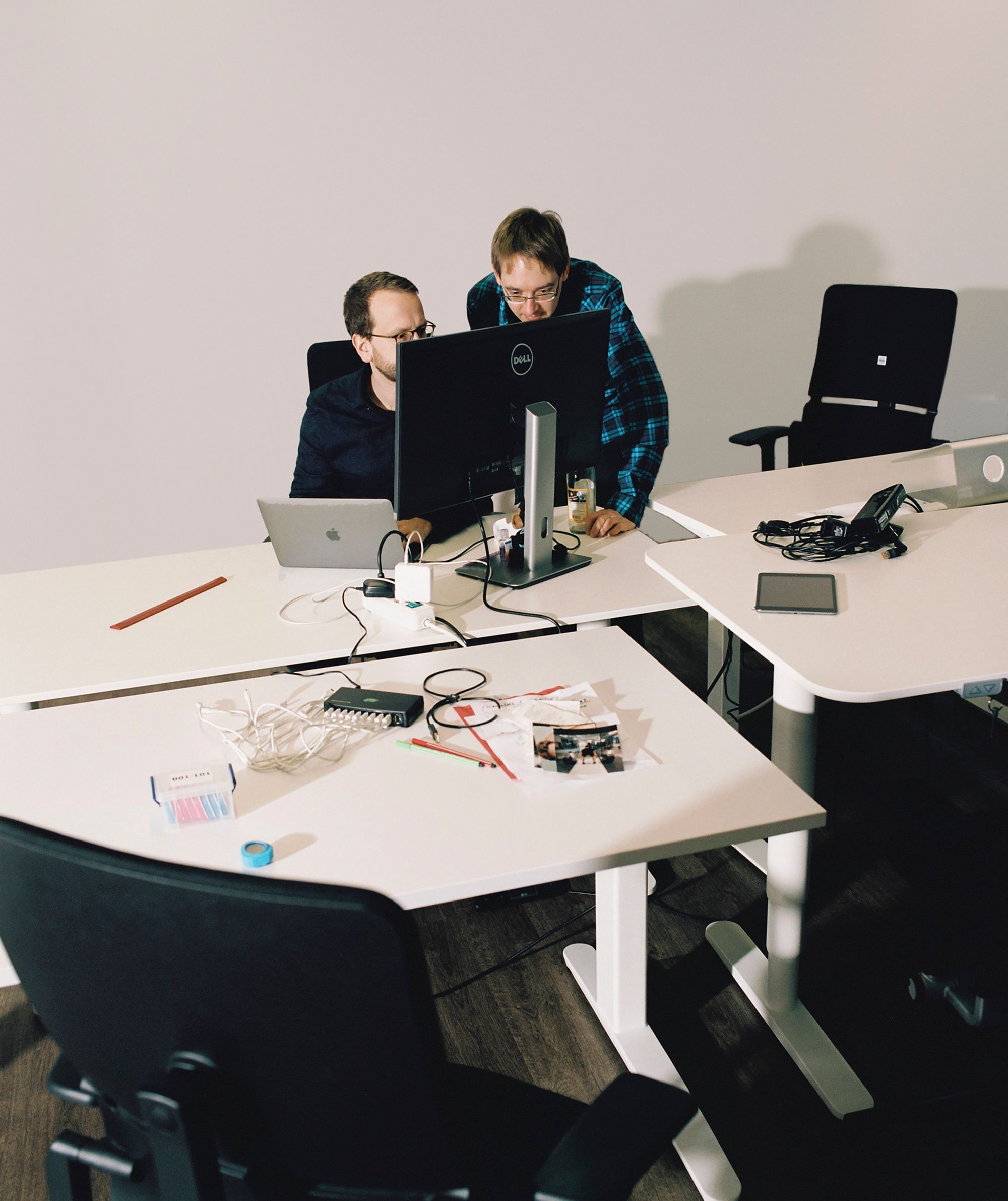 an image of two developers working together in front of one screen